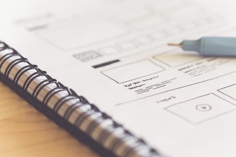 Free web design sketch ideas - a notebook with a pen on top of it