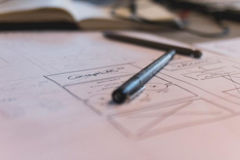 Mobile Wireframe - a pen on a piece of paper with a drawing of a house
