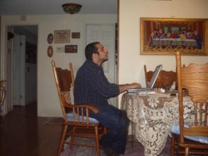 Watching and Blogging - a man sitting at a table with a laptop